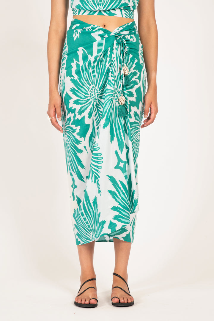 Poupette St Barth Uma long mint skirt with flowing fabric and high waist, styled for a chic summer look.