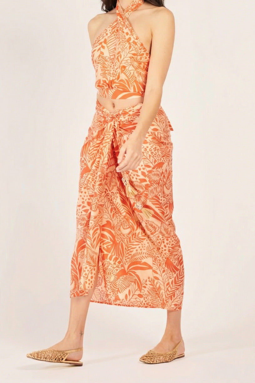 Long Uma Skirt by Poupette St Barth in vibrant orange with toucan pattern, made of lightweight cotton fabric.