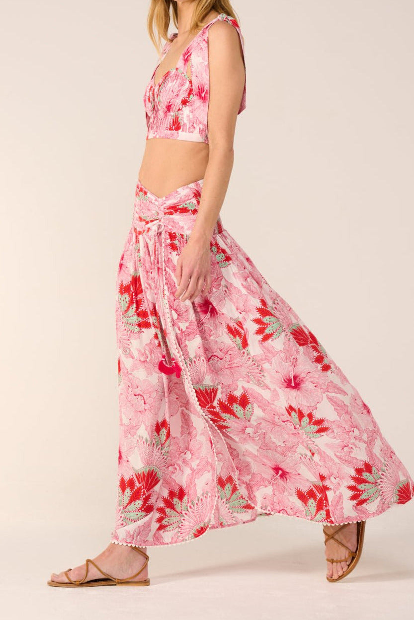 Pink long skirt Carla by Poupette St Barth, made of viscose, with a flowing design and soft fabric, shown on a model.
