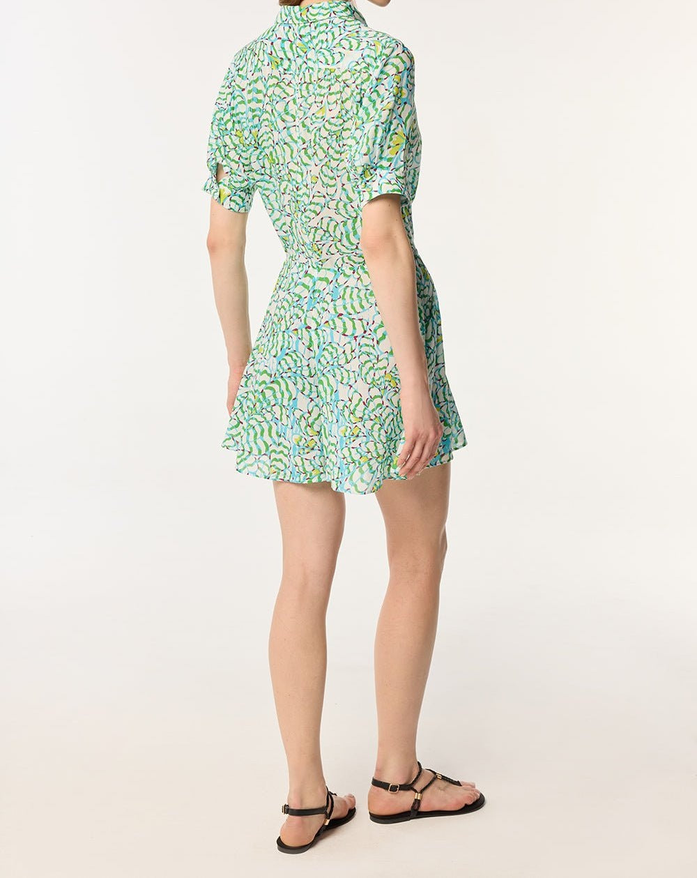 Green viscose short jumpsuit Bettina by Poupette St Barth with a floral wings pattern, shown on a model.