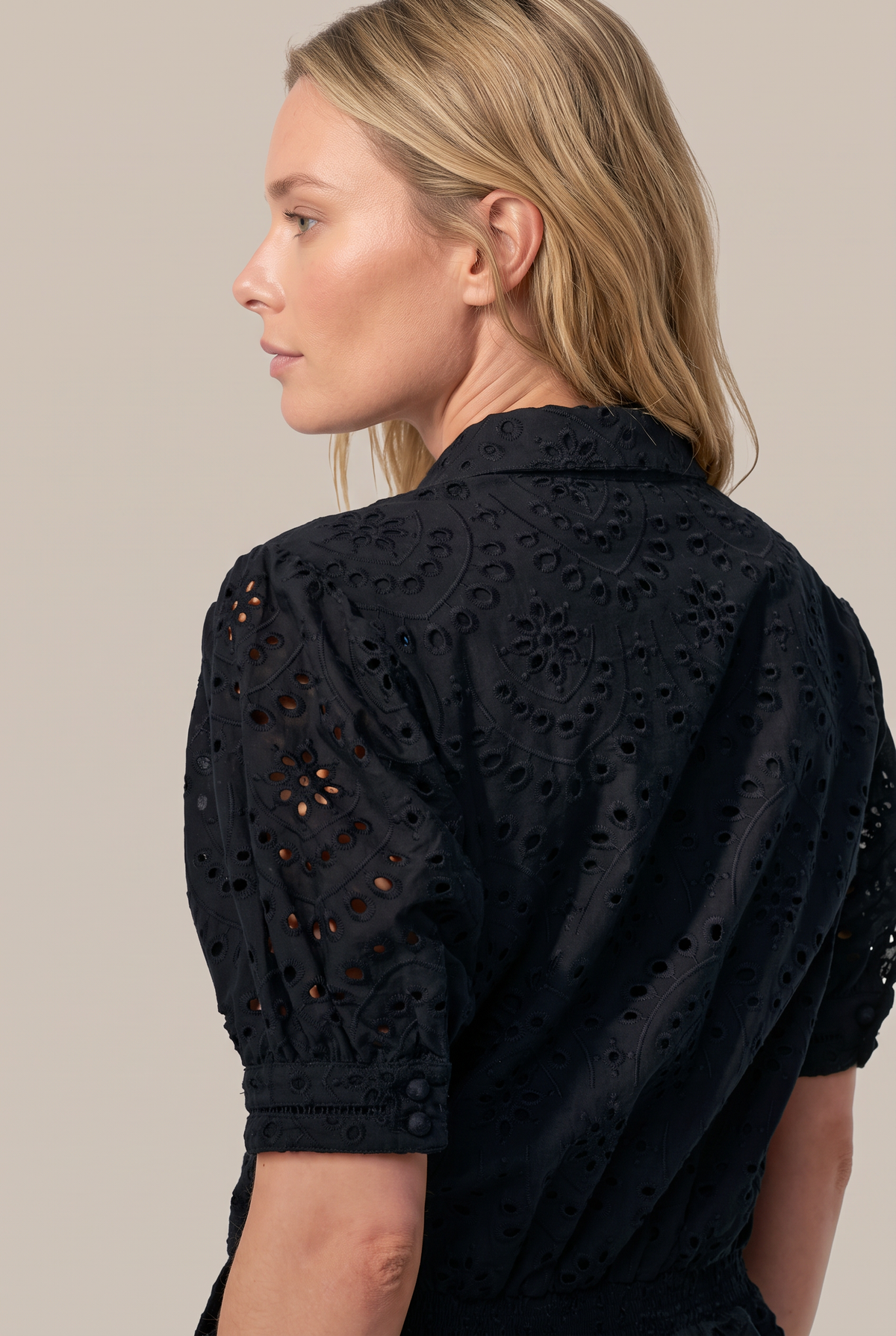 Black jumpsuit – Short Jumpsuit Livia by Poupette St Barth, side view close-up of the puff sleeve and eyelet