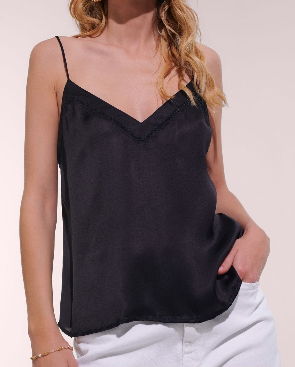 Black Laurine singlet from Poupette St Barth, made of satin viscose, featuring a sleek, sleeveless top with a simple, elegant design.