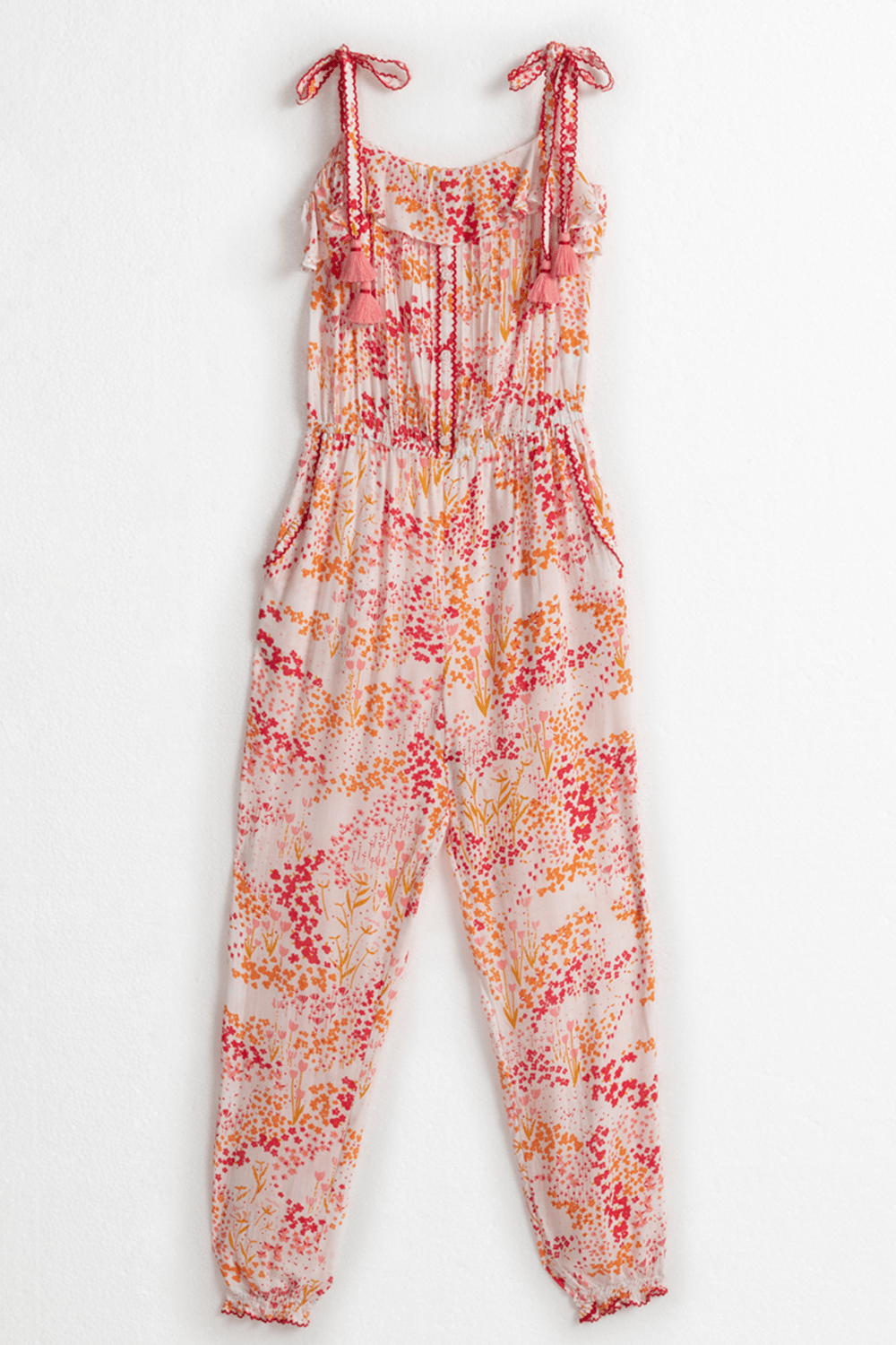 Kids long jumpsuit Astra by Poupette St Barth in white and pink tulip design, featuring a comfortable fit and playful style.