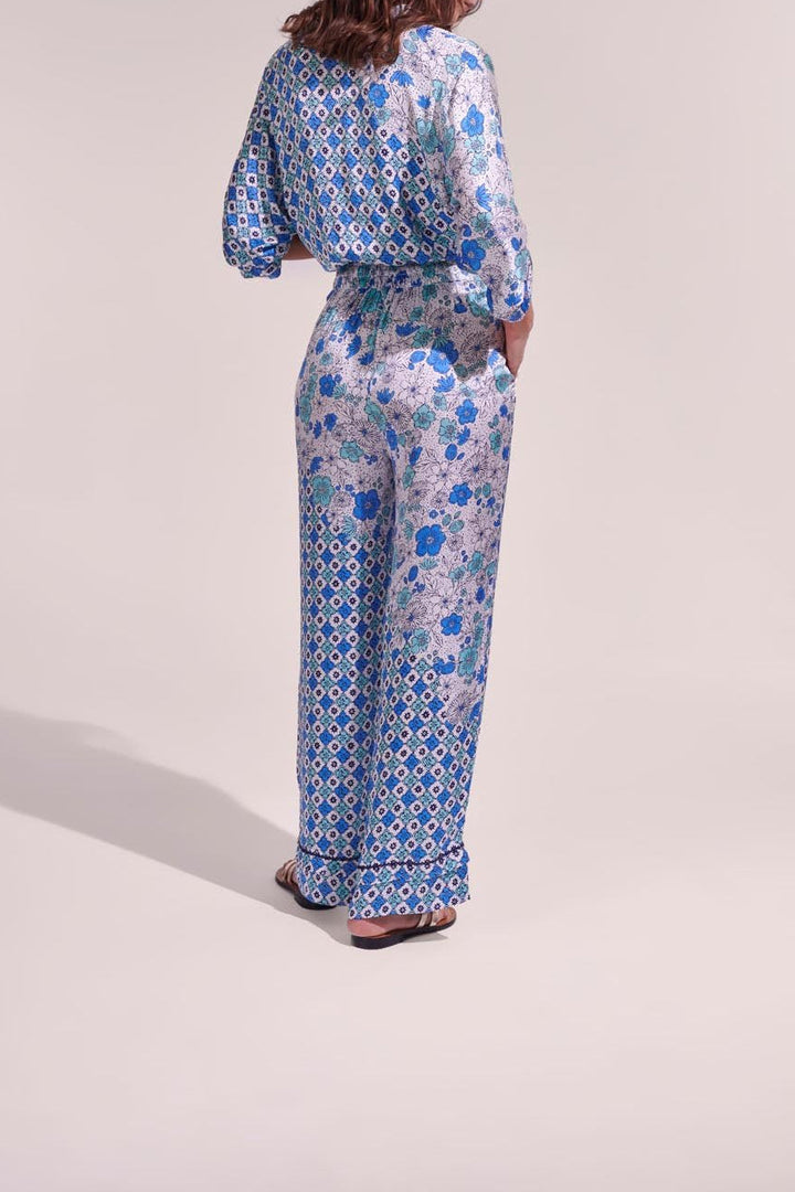 White and green diagonal batik pants from Poupette St Barth featuring a relaxed fit and stylish tropical pattern.