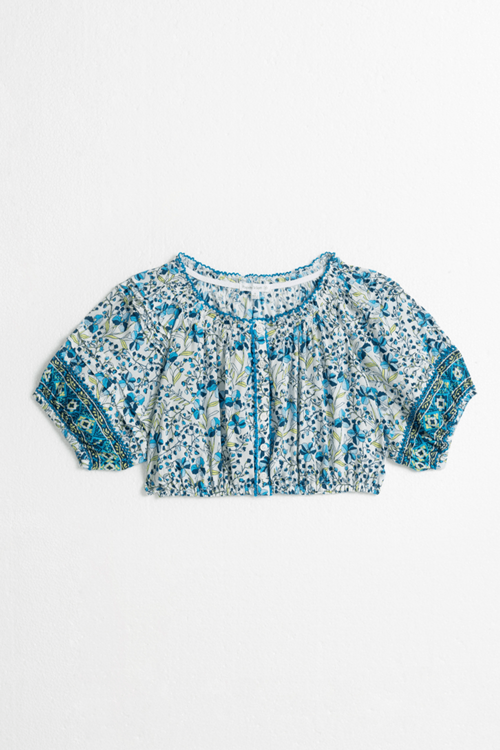 Blue kids' top Andrea by Poupette St Barth featuring a stylish mini jonquille pattern, shown from the front.
