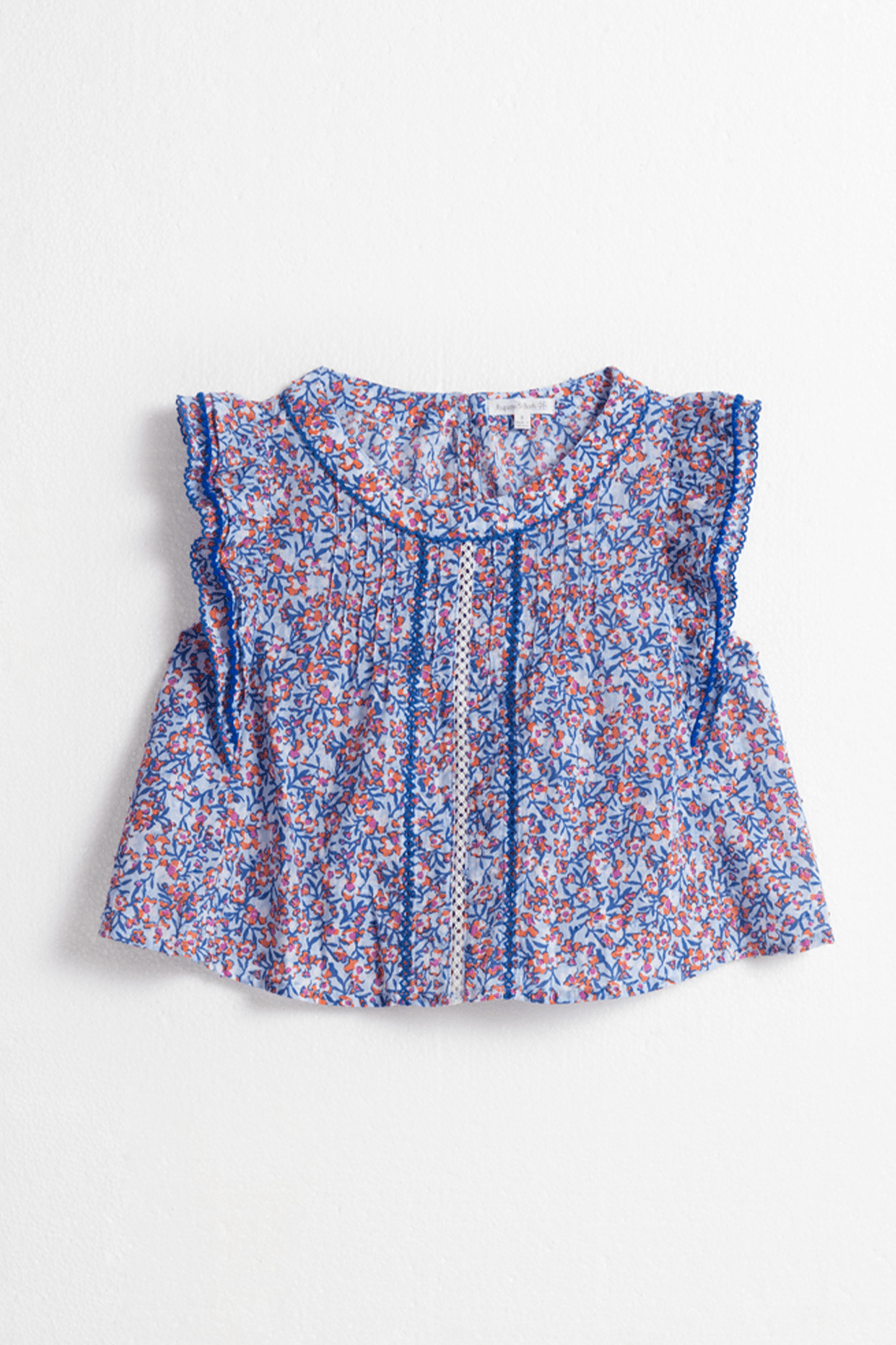 Light blue kids' top by Poupette St Barth featuring a playful paquerette pattern, front view of the shirt.