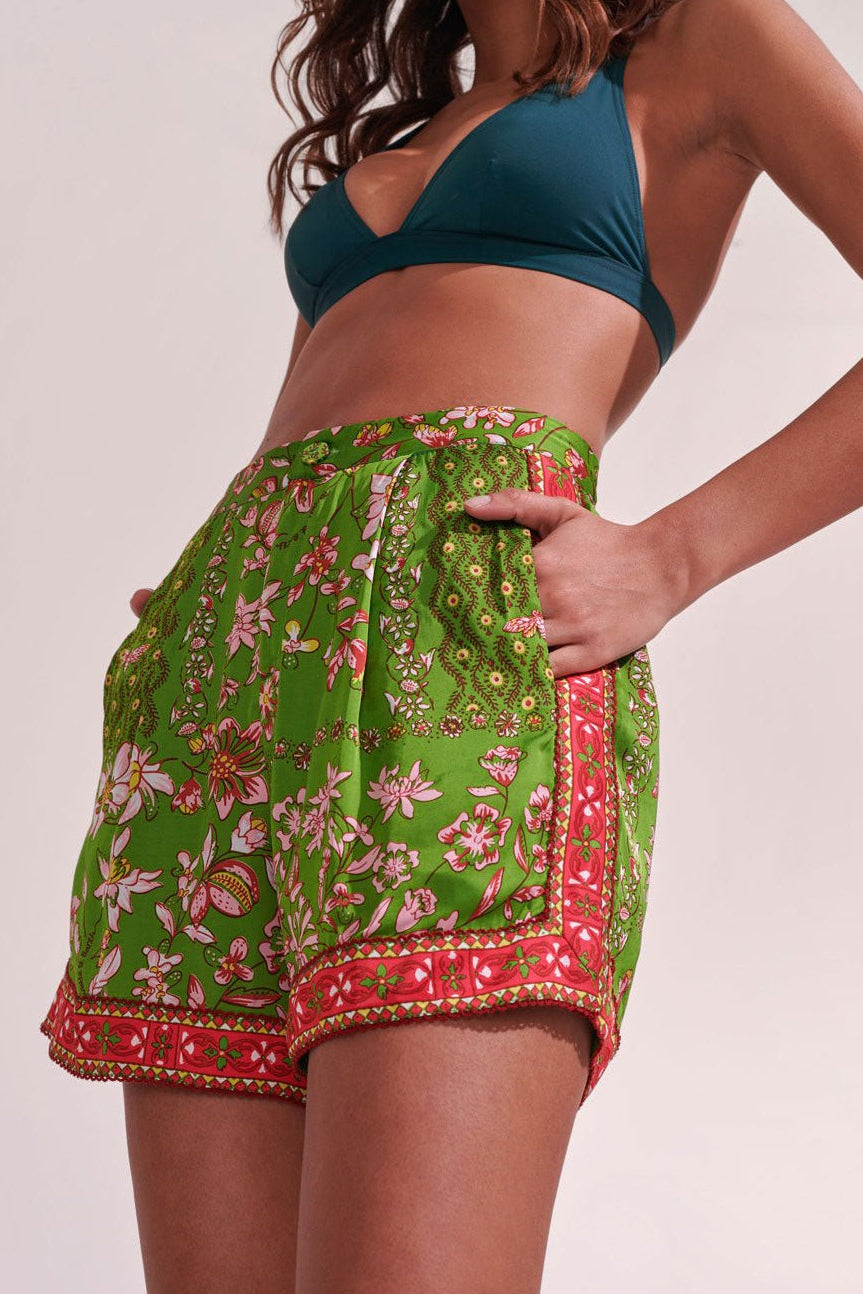 Green Botanique Short Isabelle by Poupette St Barth with floral print and relaxed fit, shown on a model.