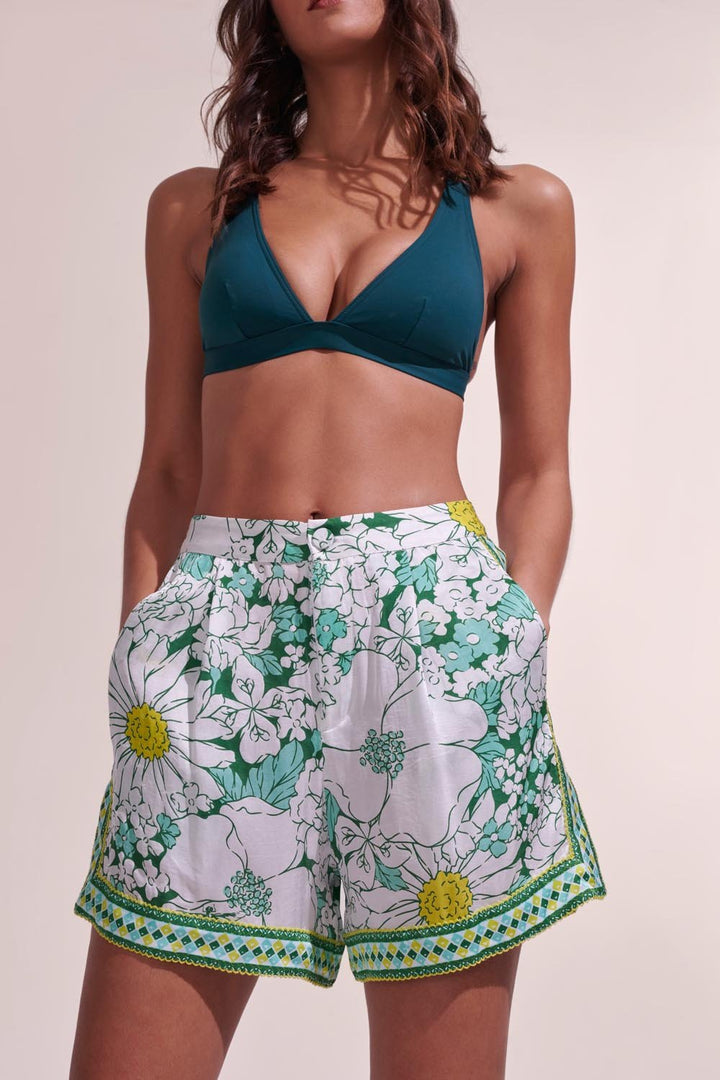 Poupette St Barth Isabelle green macro 70s garden shorts featuring a vibrant floral pattern and relaxed fit.