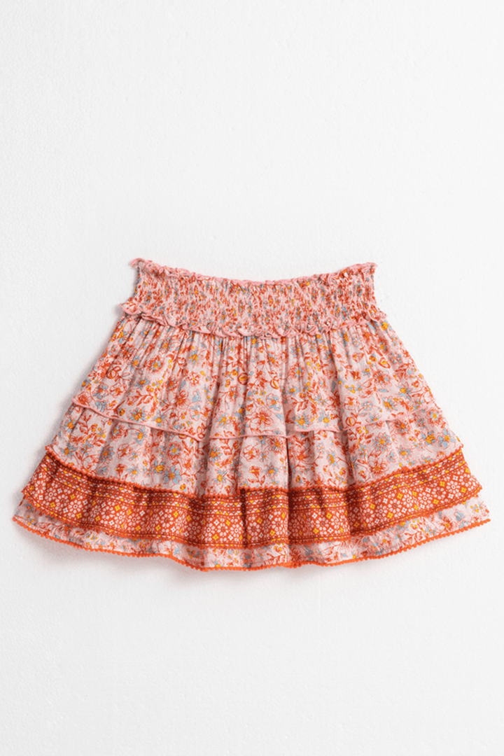 Kids mini skirt Ariel in pink magnolia by Poupette St Barth, shown from the back with a ruffled hem and playful design.